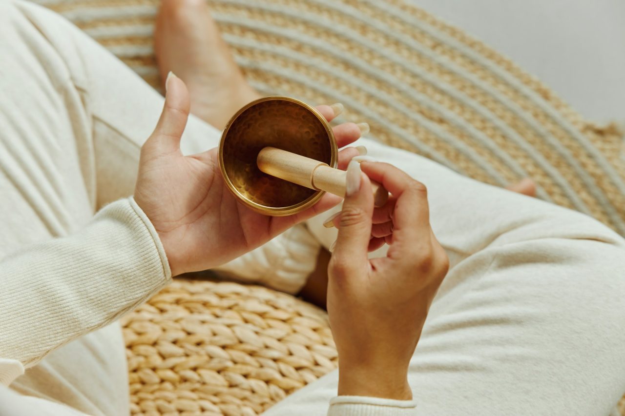 top-view-of-woman-using-singing-bowl-in-sound-healing-therapy-.jpg